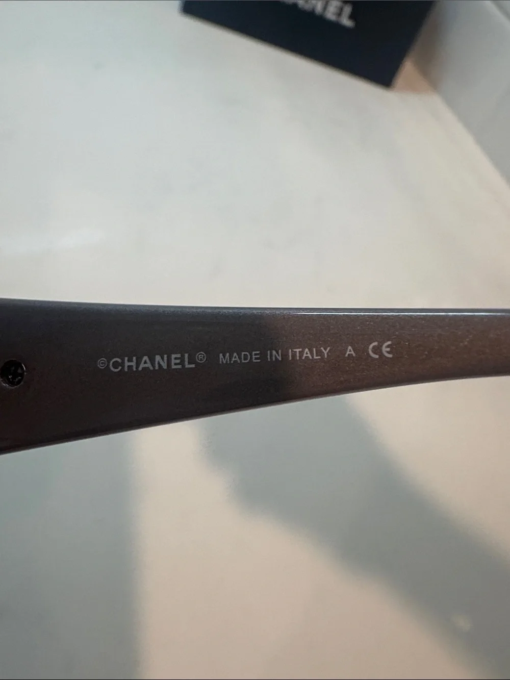 Chanel  Camellia flower with crystal-embellished interlocking CC logo